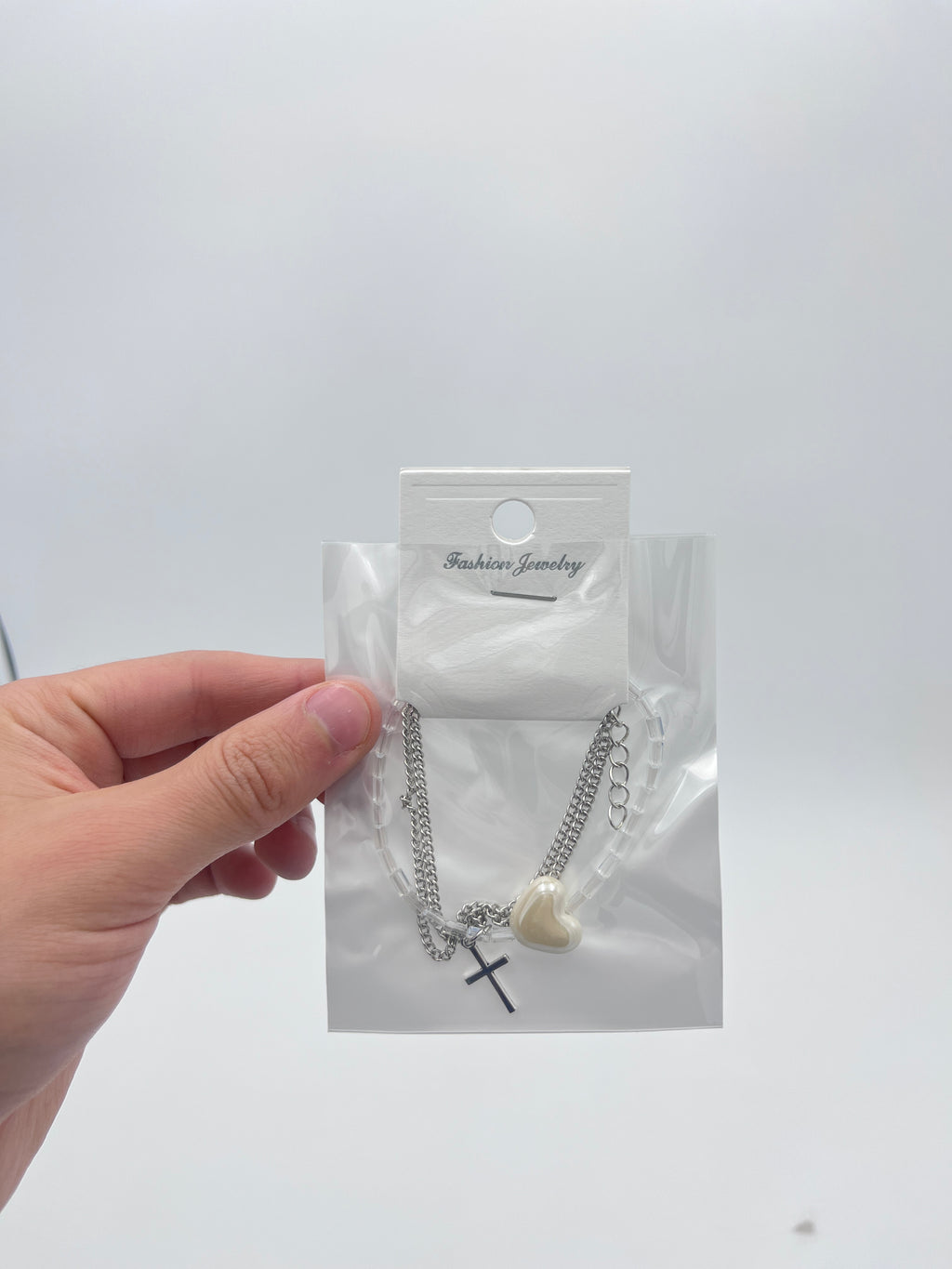 Pulsera Triple Plateada Corazón y Cruz - Paquete de 12 piezas 14.08 c/u