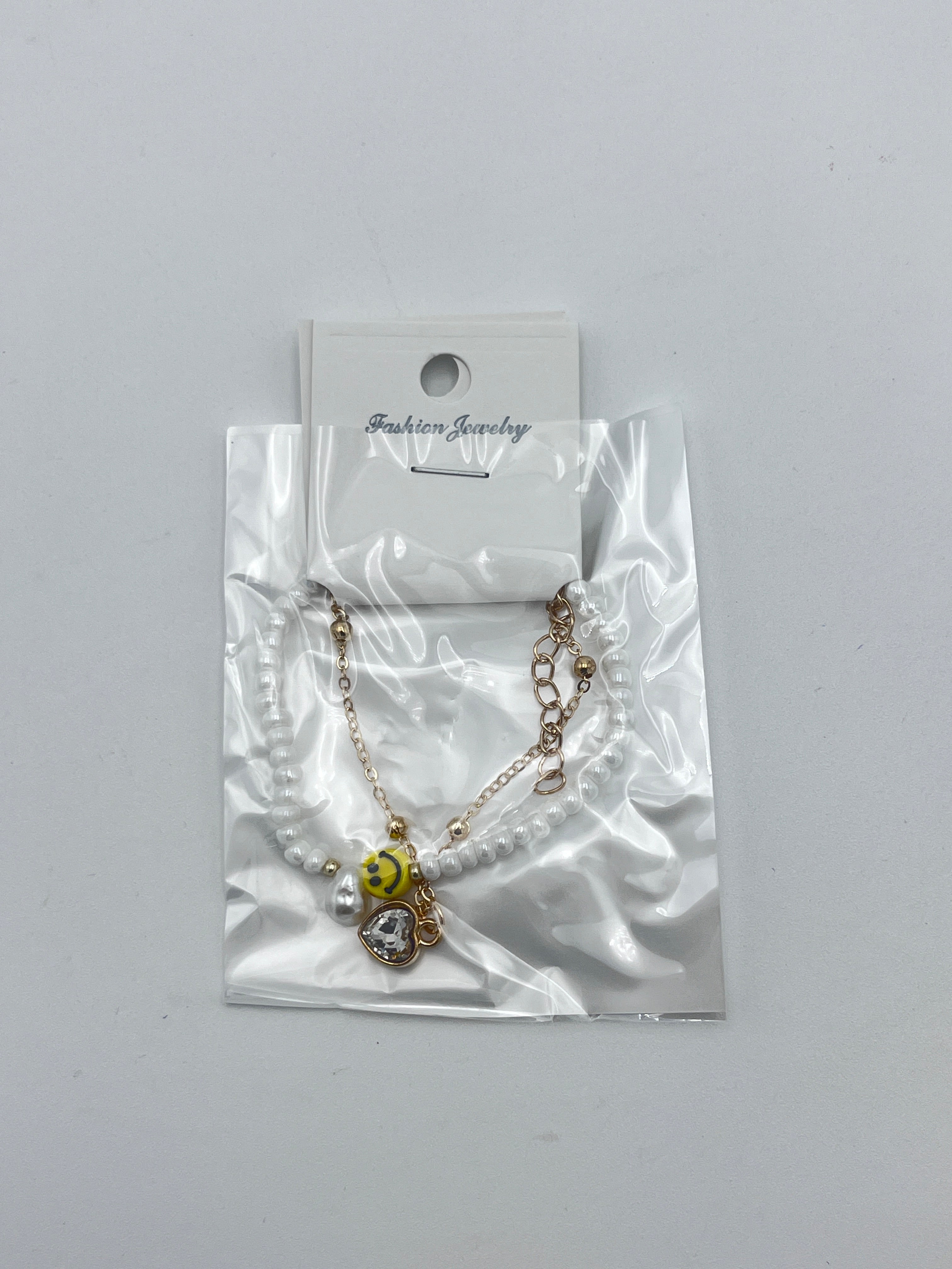 Pulsera Doble Capa con Cuentas Blanca y Carita Feliz - Paquete de 12 piezas 14.08 c/u