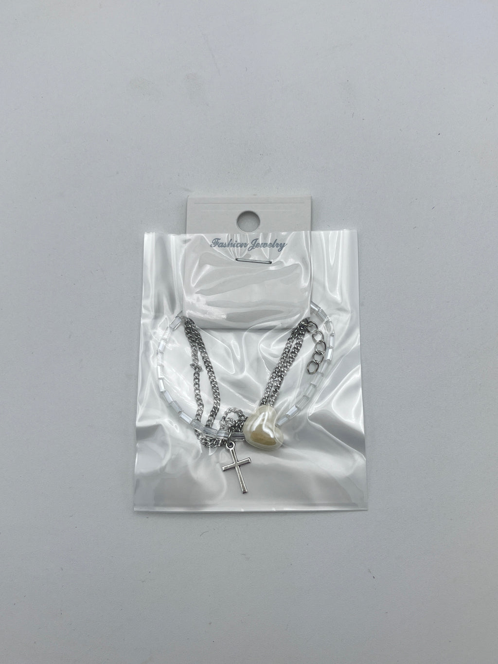 Pulsera Triple Plateada Corazón y Cruz - Paquete de 12 piezas 14.08 c/u